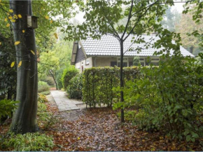 Cozy house with a fireplace in a holiday park in a natural area